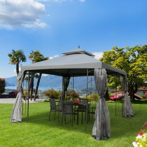 Gazebo cinzento com mesa num jardim em frente ao lago