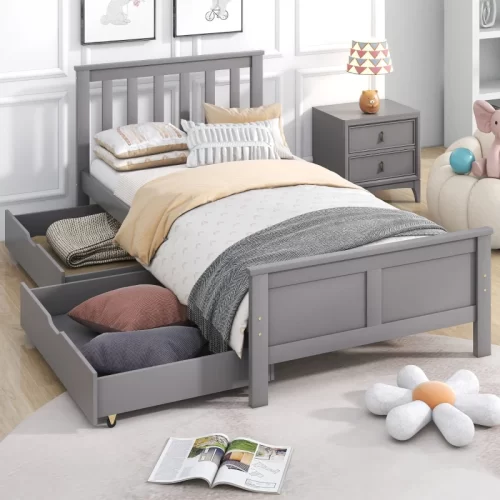 Cama sommier cinzenta com gavetas abertas cheias de roupa de cama
